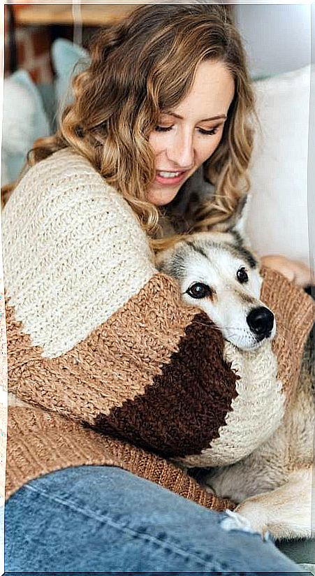 Woman with dog on sofa in winter