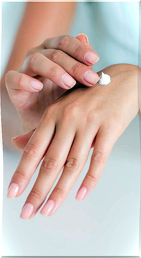 Woman putting on hand cream