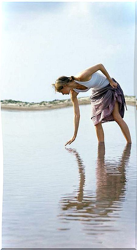 Woman crouching in the sea